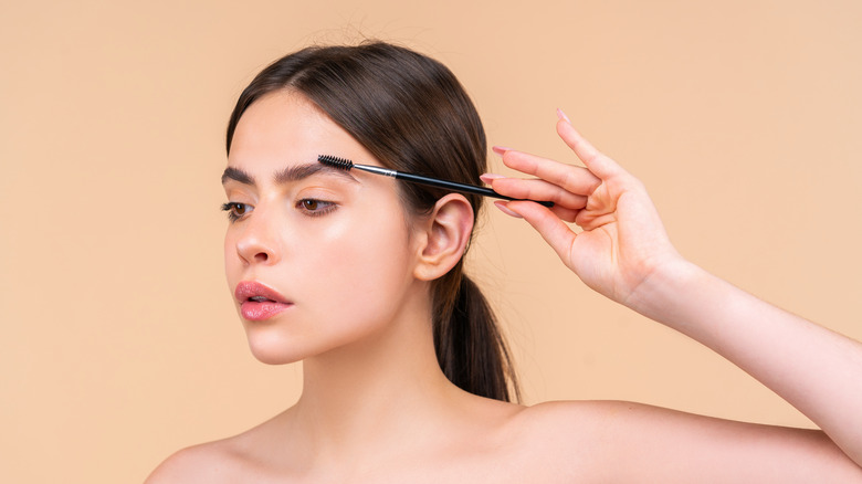 woman styling eyebrows