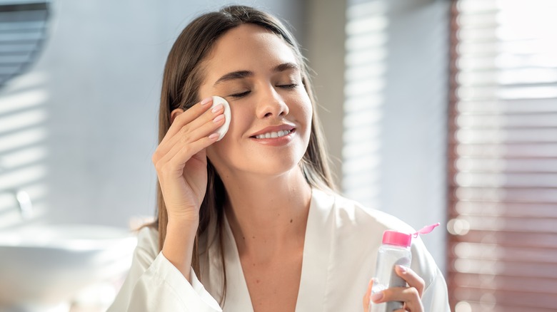 woman applying skincare product