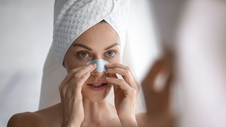 woman applying pore strip