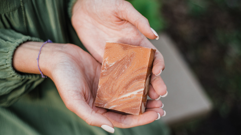 Woman holding orange soap