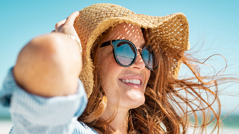 Woman wearing sunhat and sunglasses