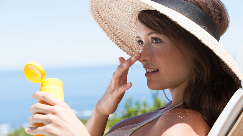 A woman applying sunscreen