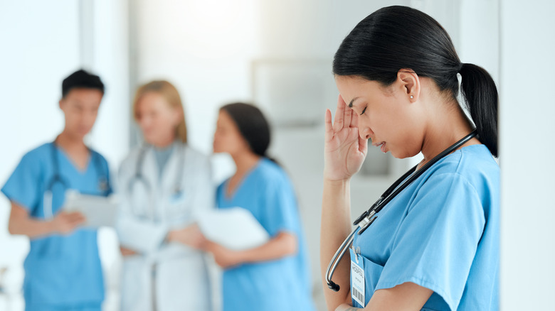 Woman with headache in a work scenario