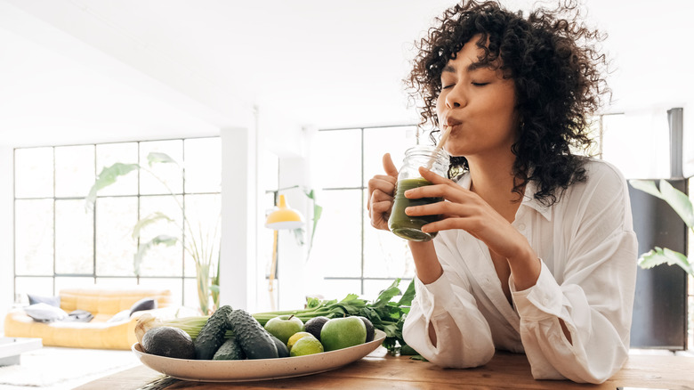 You woman drinks green smoothie