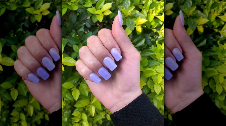 hand with digital lavender nails