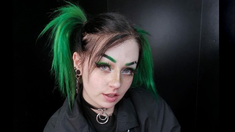Black hair in pigtails with green dip dye