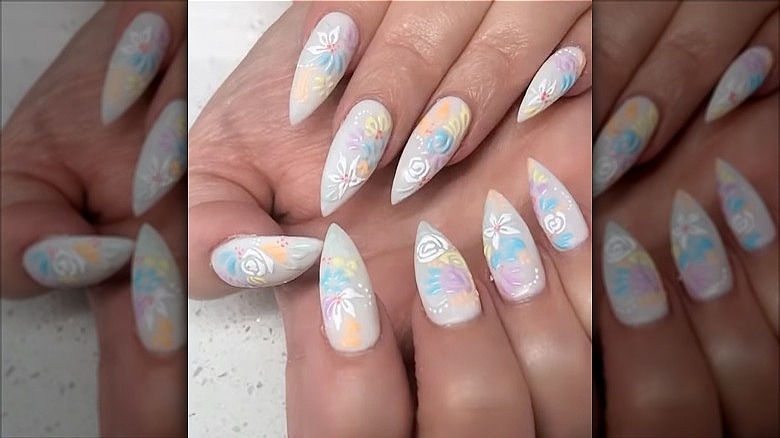 hands with floral design dip powder nails
