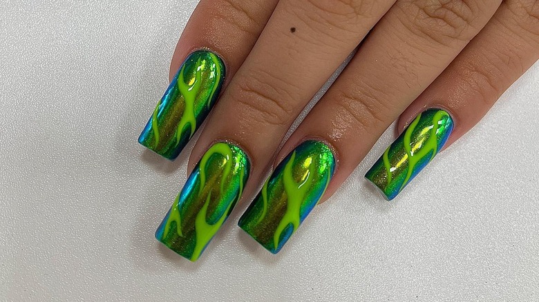 woman with sparkling green nails
