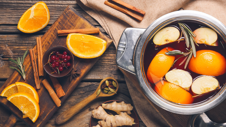 Pot with oranges, apples, rosemary, ginger, cinnamon