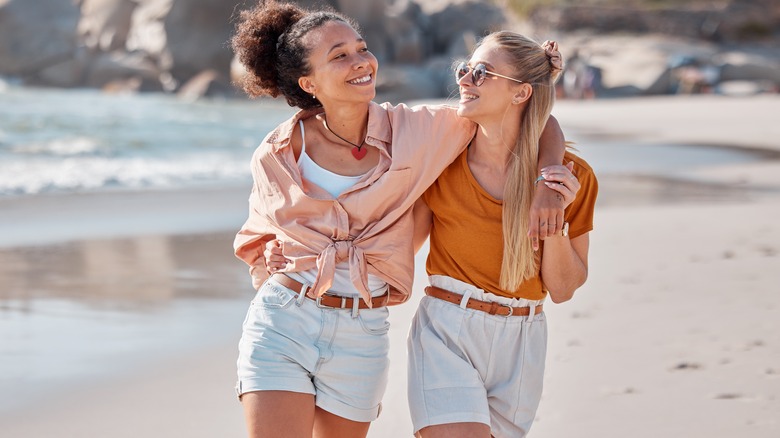 Couple walks on beach