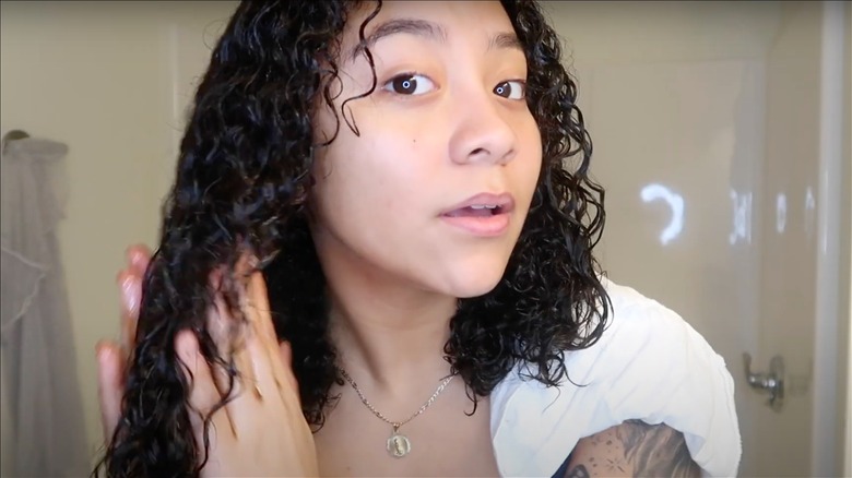 Woman applying cinnamon to hair