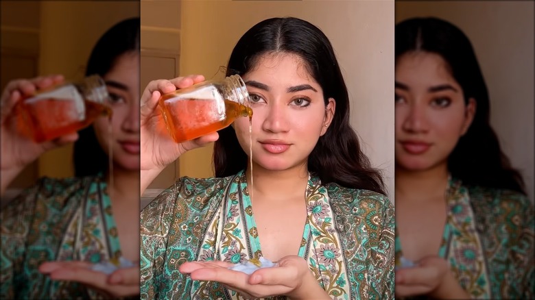 Woman pouring honey onto hand