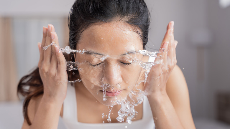 woman rinsing her face