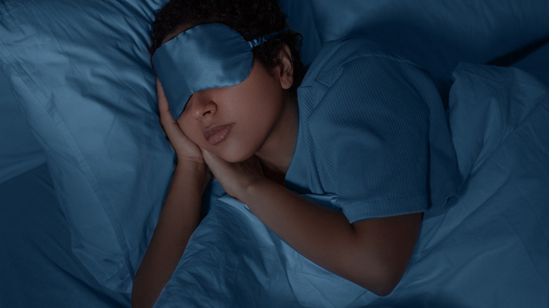 female sleeping wearing an eye mask