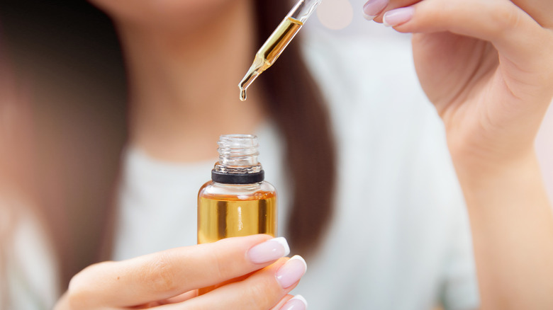 woman holding oil bottle