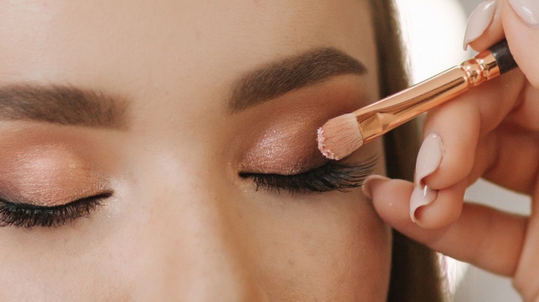 Applying eyeshadow with brush