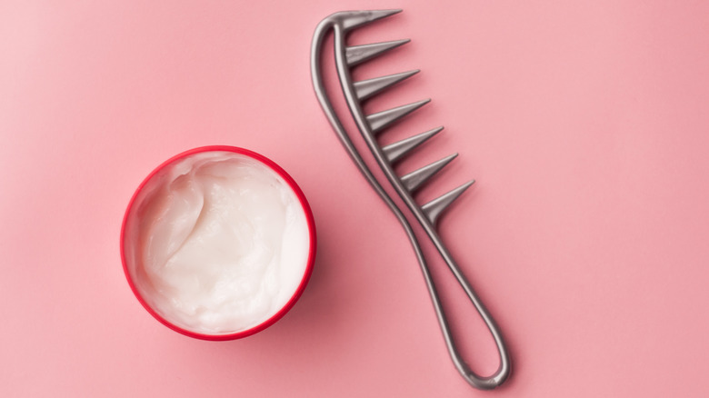 Hair mask and comb on pink background