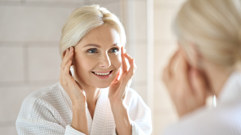 woman looking in the mirror