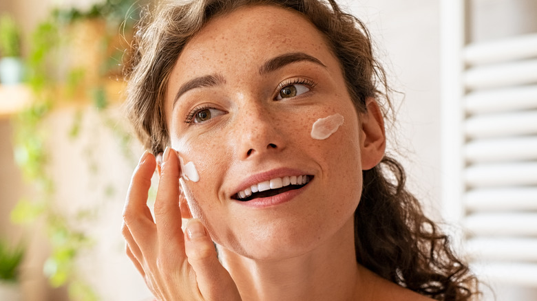 woman applying skin cream