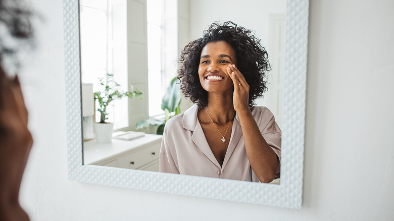 woman using cotton pad on face