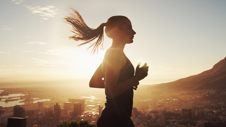 Woman jogging before scenic view