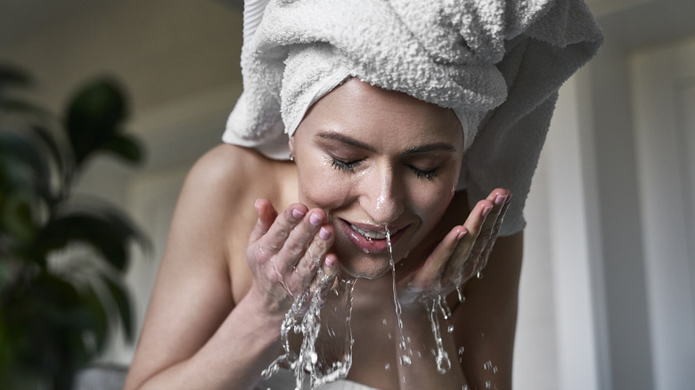 woman cleansing face