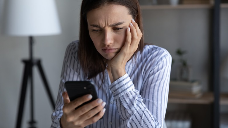Upset woman waiting for text
