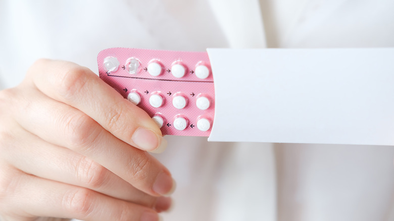 Birth control pills on a person's hand
