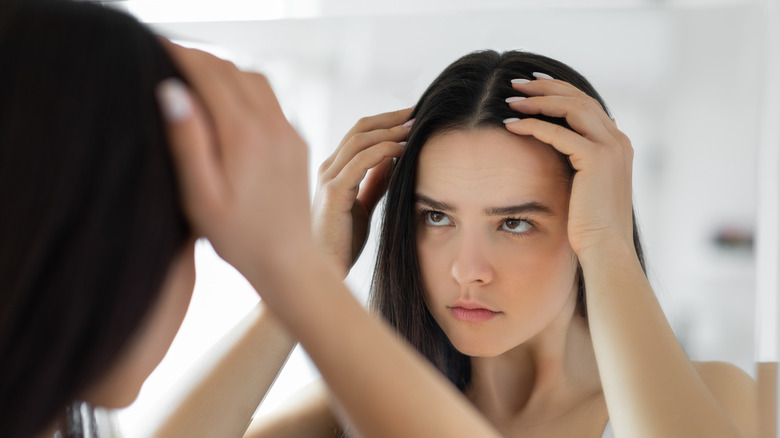 Girl checking her thinning hair