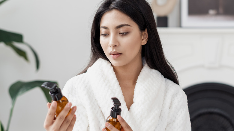 female checking body lotion