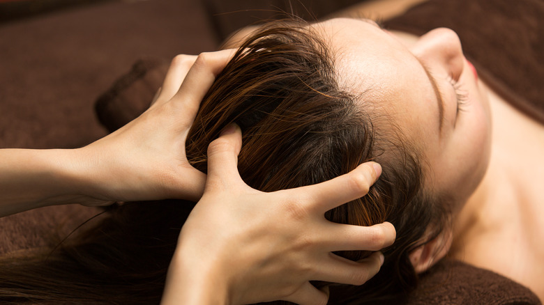 Woman receives scalp massage