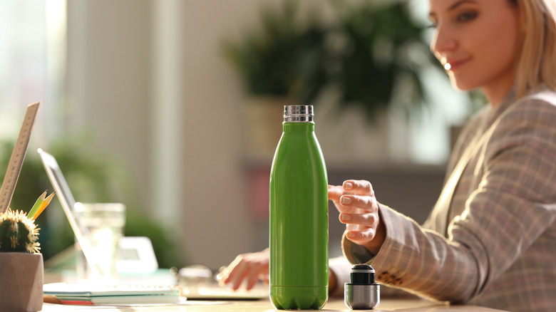 woman reaching for bottle