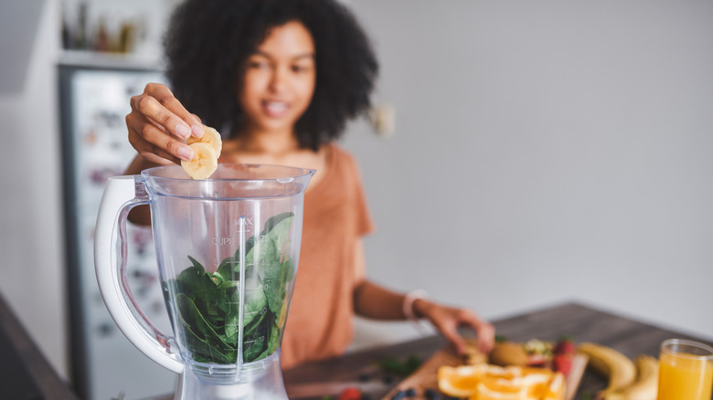 A woman making a smoothie