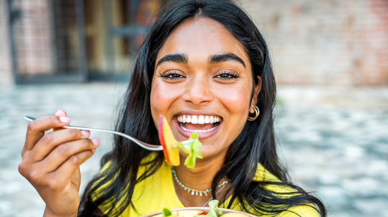 A woman eating a salad