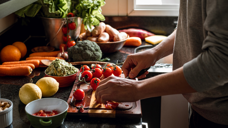 A person cutting tomatoes