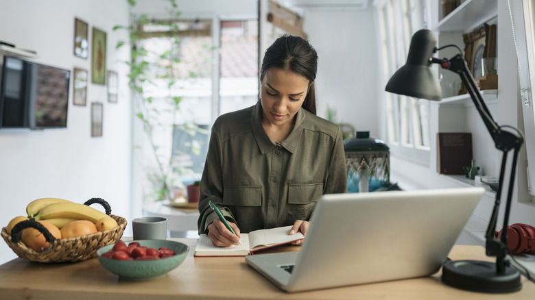 woman writing in planner