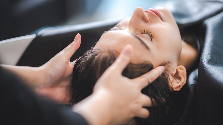 Woman receiving hair treatment