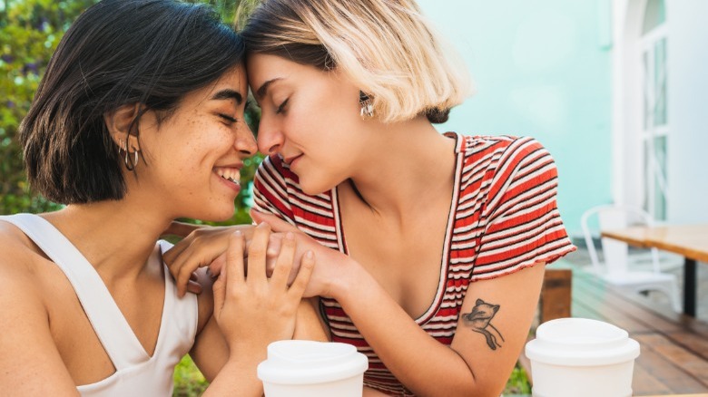 Girlfriends smiling close together