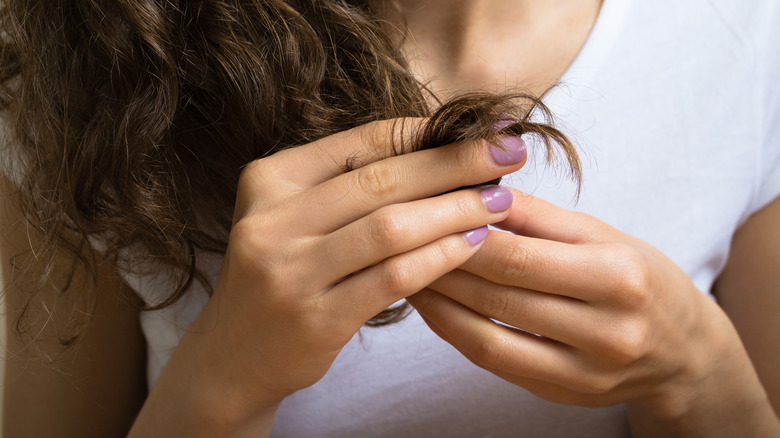 woman looking at split ends