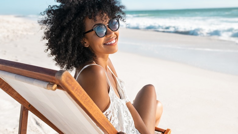 Woman sunbathes on beach