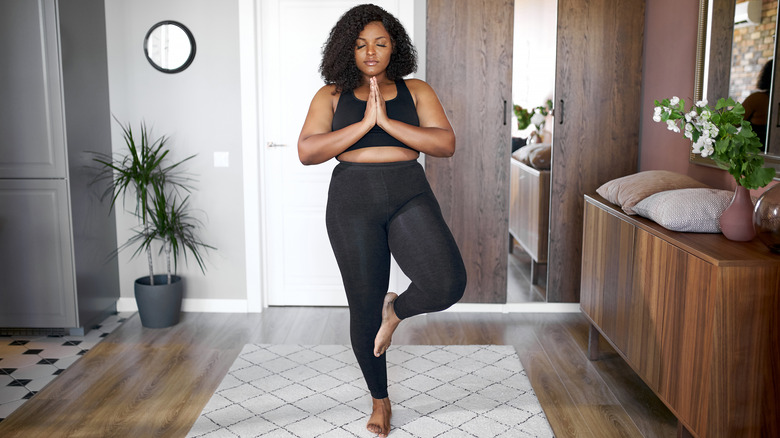 woman doing yoga at home