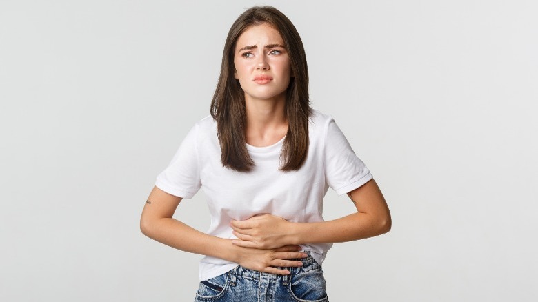 Woman in pain holding stomach