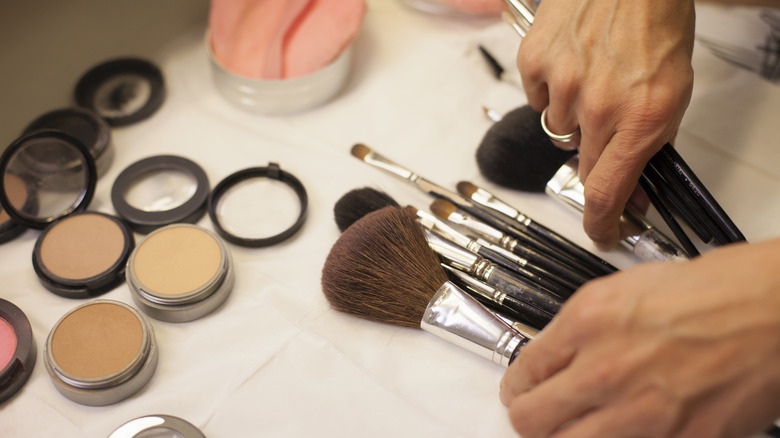 A woman organizing her makeup brushes.