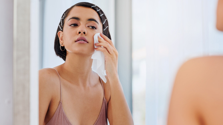 A woman removing her makeup.