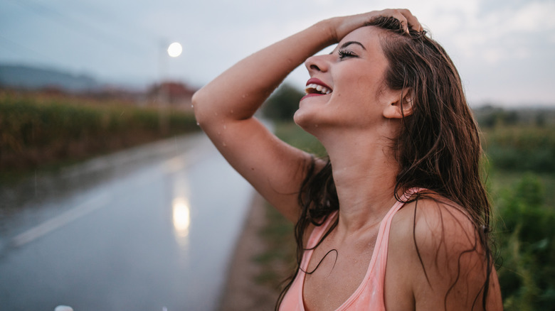 A woman smiling in the rain.