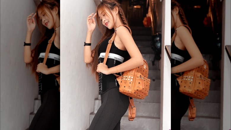 Girl carrying MCM backpack.