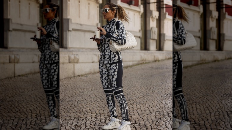 Woman carrying a dior bowling bag.