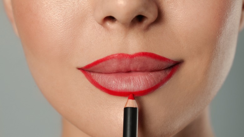 woman applying lip liner