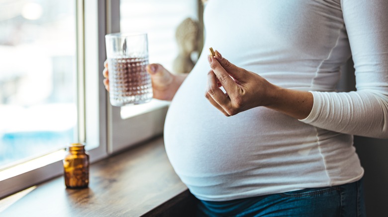 pregnant woman taking supplement