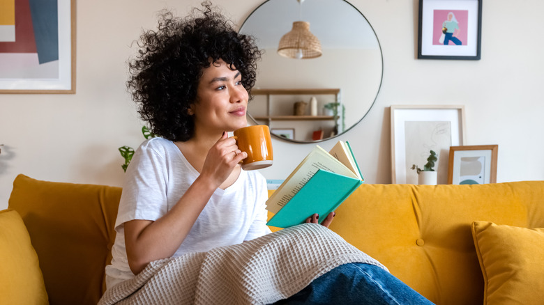 Woman drinking coffee and reading